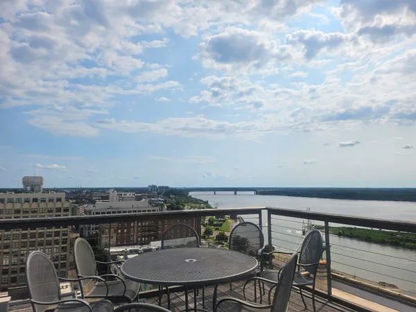 a roof deck with a table and chairs