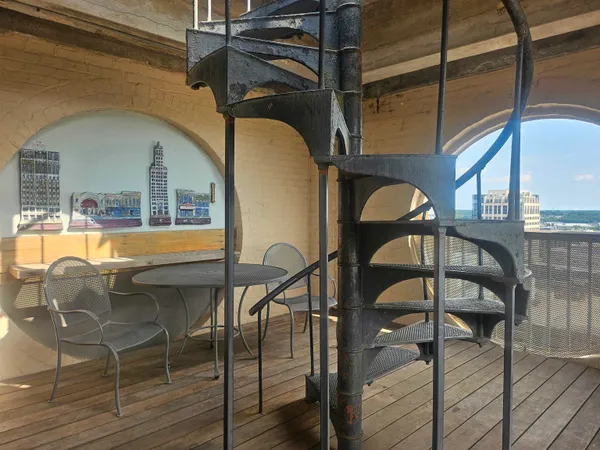 a view of a balcony next to a yard