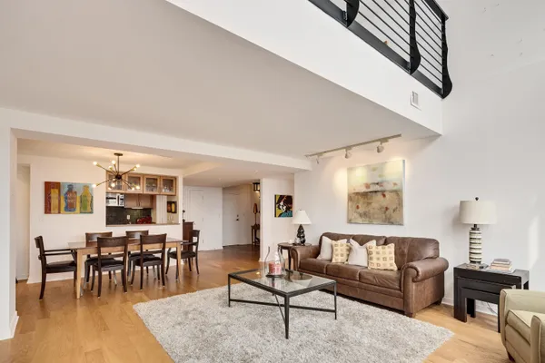 a living room with furniture and wooden floor