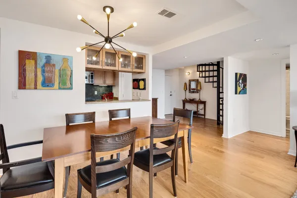 a dining room with furniture and wooden floor