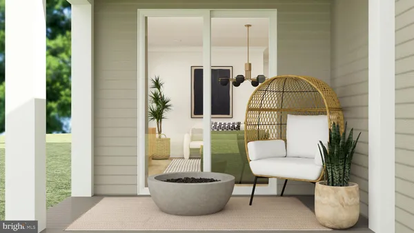 a living room with furniture a potted plant and a lamp