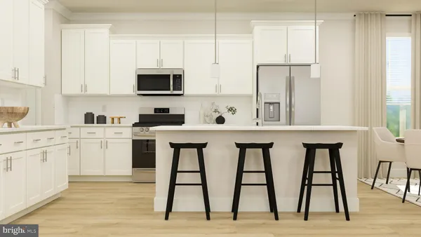 a kitchen with white cabinets and sink