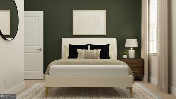 a bedroom with a bed a mirror and lamp