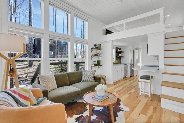 a living room with furniture and a floor to ceiling window