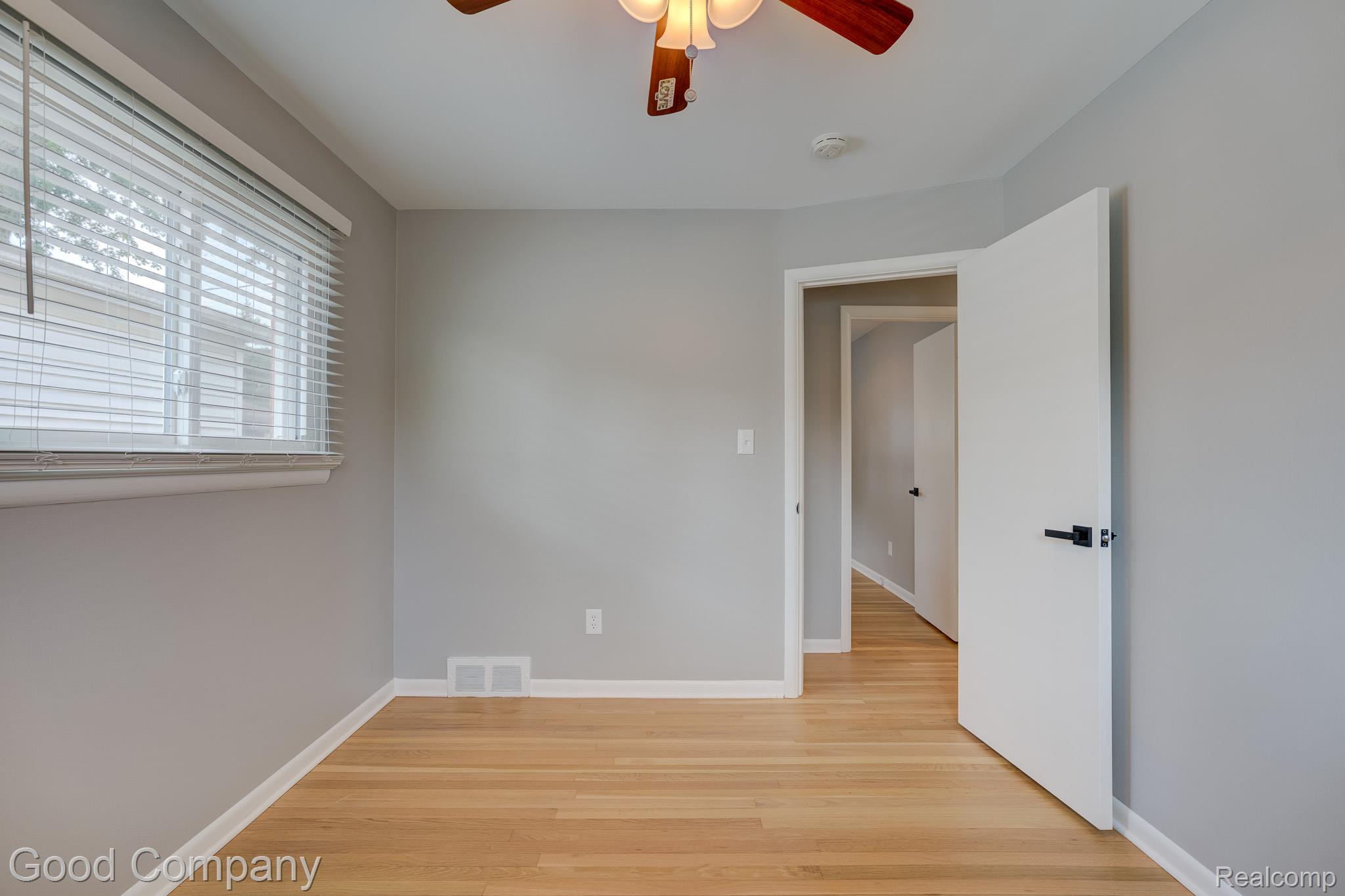 1842 Massoit Road Royal Oak, MI 48073 - Photo 22 of 52 Wood-finish flooring, light gray wall paint, and a ceiling fan with integrated lighting