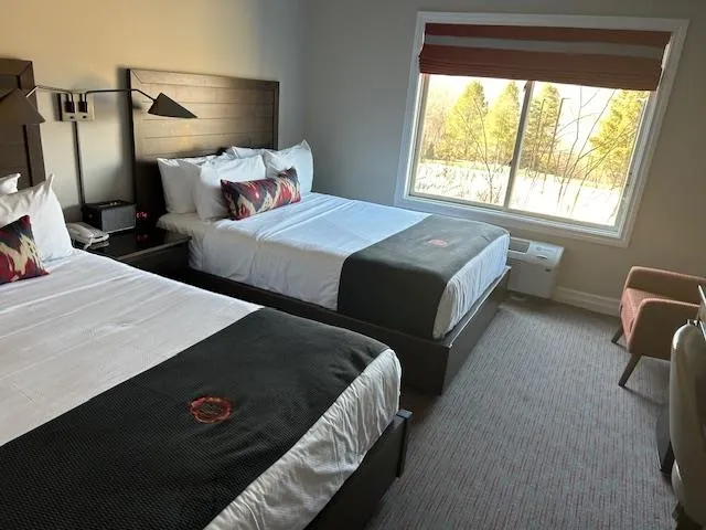 a bedroom with two beds and a window