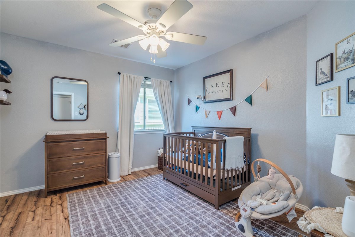 175 Wetzel Kyle, TX 78640 - Photo 18 of 27 This tranquil room offers hardwood flooring and a bright window with a ceiling fan for comfort.