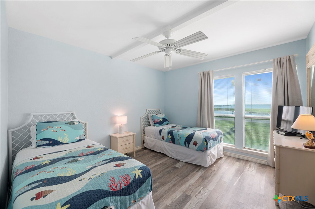 2003 North Fulton Beach Road, Unit 77 Rockport, TX 78382 - Photo 20 of 33 a bedroom with two beds and a large window