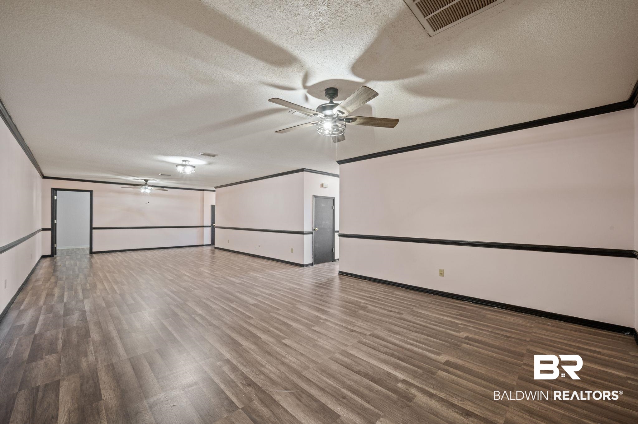 100 Orleans Way Daphne, AL 36526 - Photo 14 of 31 Empty room featuring ceiling fan, crown molding, a textured ceiling, and hardwood / wood-style flooring