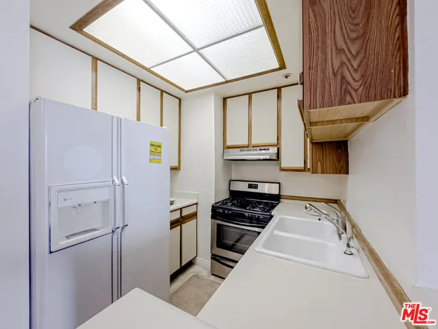 a kitchen with stainless steel appliances a refrigerator and a stove
