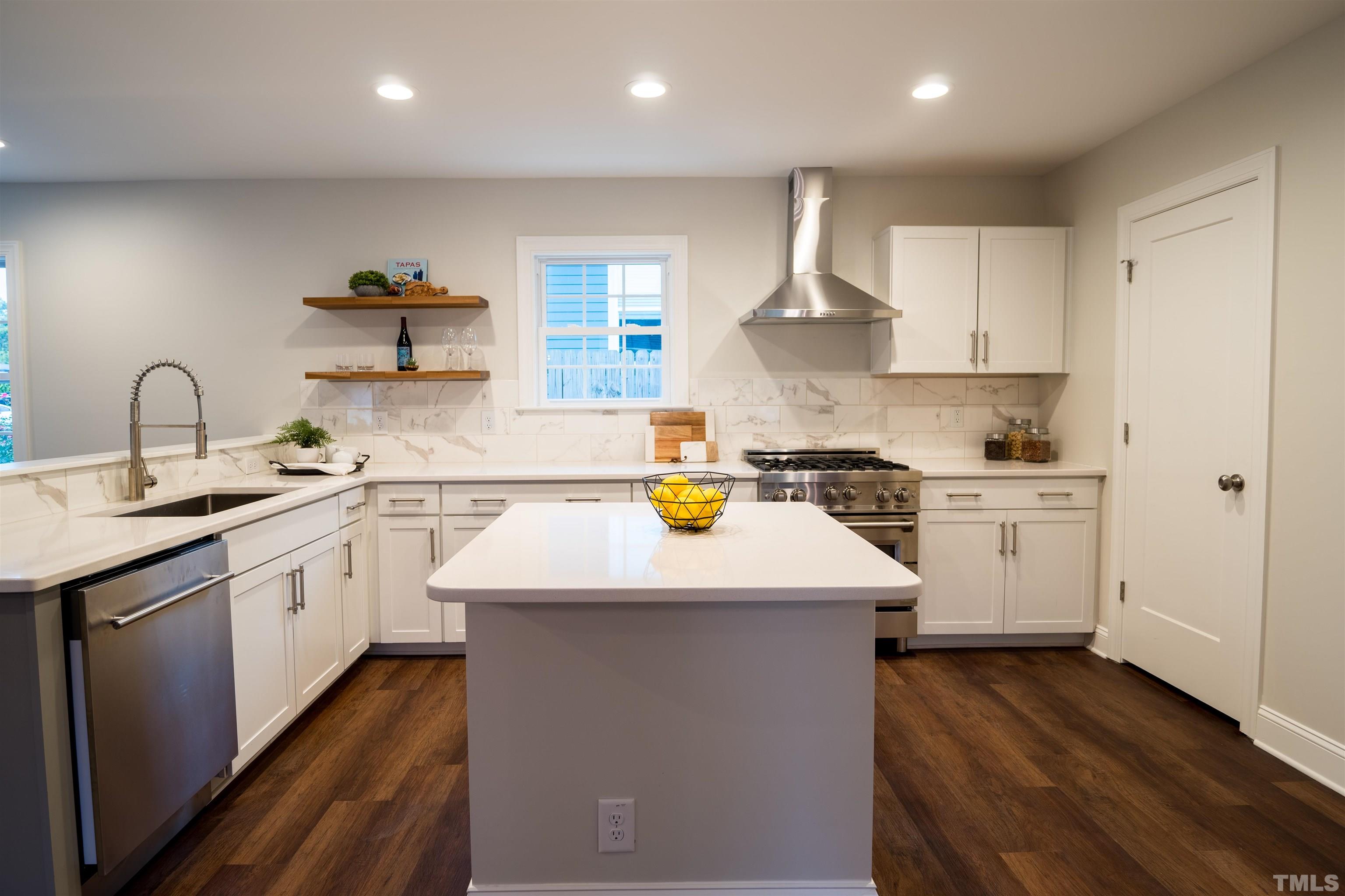 910 South East Street Raleigh, NC 27601 - Photo 13 of 17 a kitchen with a sink white cabinets and white appliances