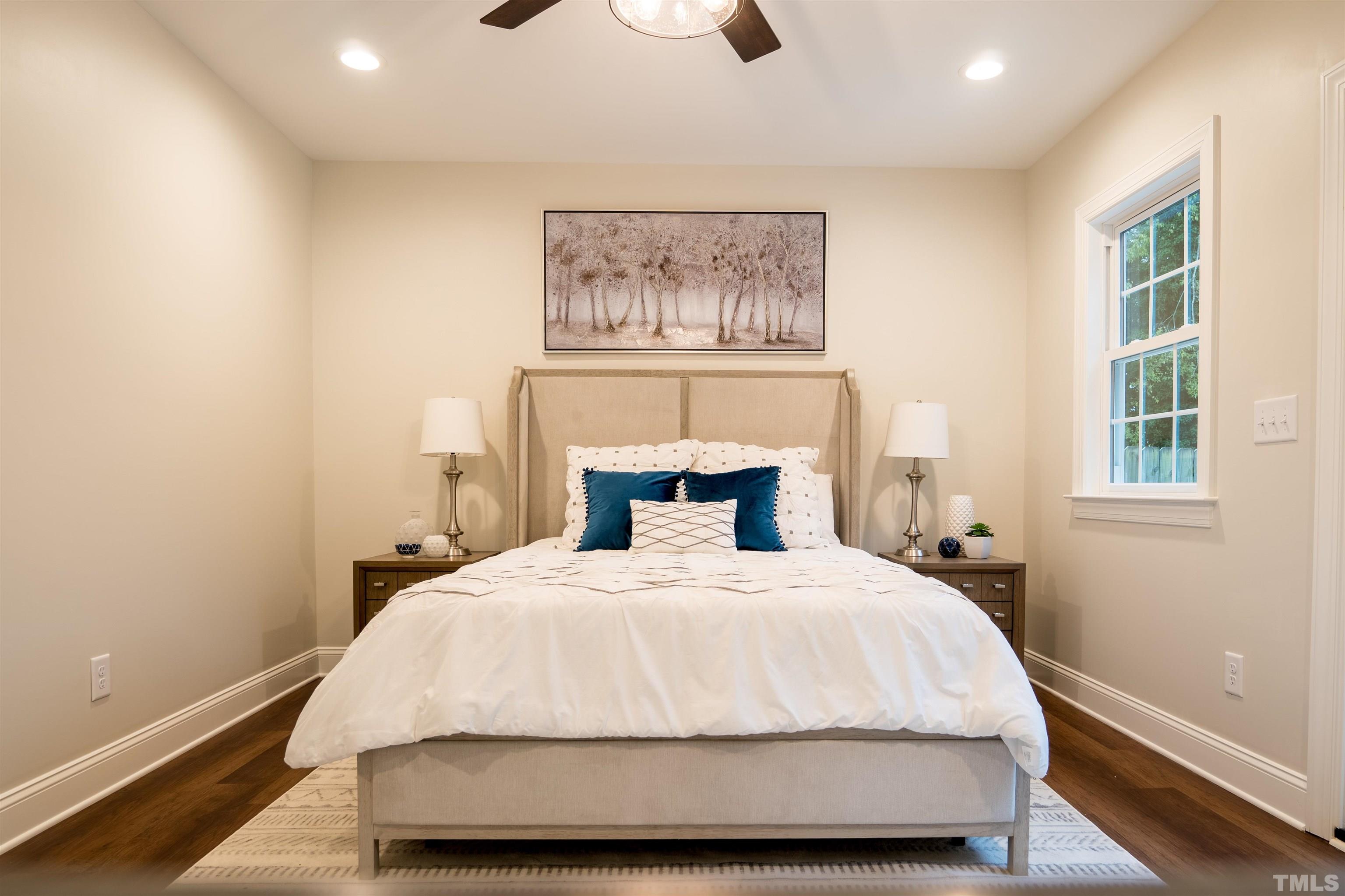 910 South East Street Raleigh, NC 27601 - Photo 17 of 17 a bedroom with a bed and a painting on the wall