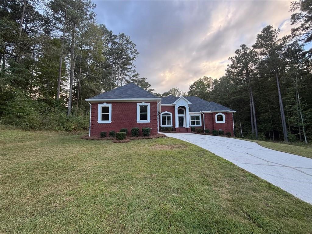 1487 Mt Zion Road Oxford, GA 30054 - Photo 1 of 18 a view of a yard in front of a house with large trees