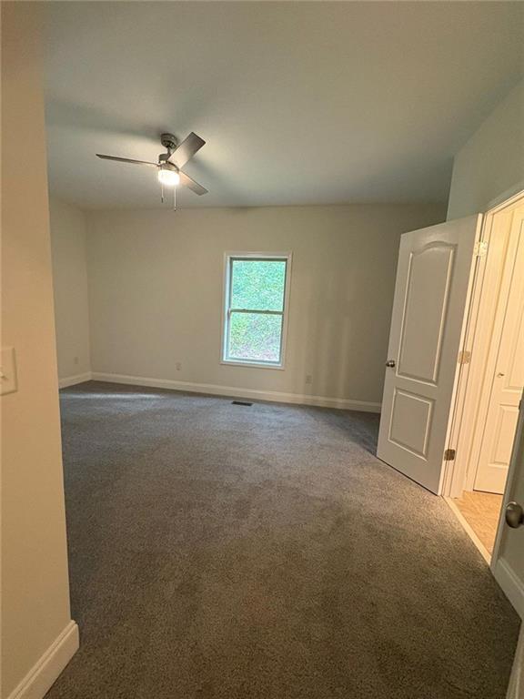 1487 Mt Zion Road Oxford, GA 30054 - Photo 14 of 18 an empty room with windows and fan