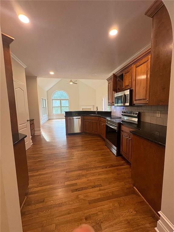 1487 Mt Zion Road Oxford, GA 30054 - Photo 7 of 18 a large kitchen with stainless steel appliances granite countertop a stove a sink dishwasher and a microwave oven with wooden floor