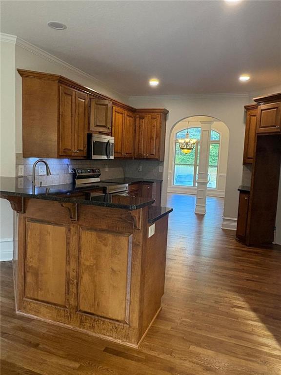1487 Mt Zion Road Oxford, GA 30054 - Photo 8 of 18 a kitchen with stainless steel appliances granite countertop a stove a sink and a refrigerator