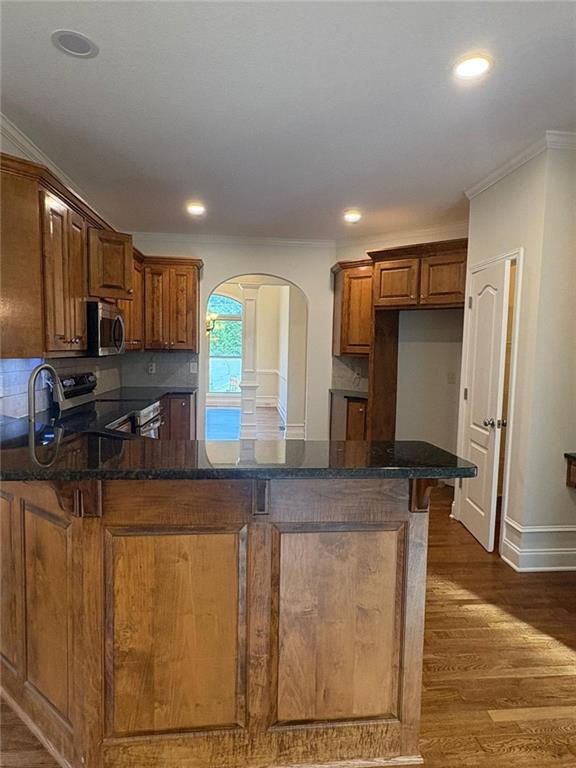 1487 Mt Zion Road Oxford, GA 30054 - Photo 9 of 18 a kitchen with stainless steel appliances granite countertop a sink a stove counter space and cabinets