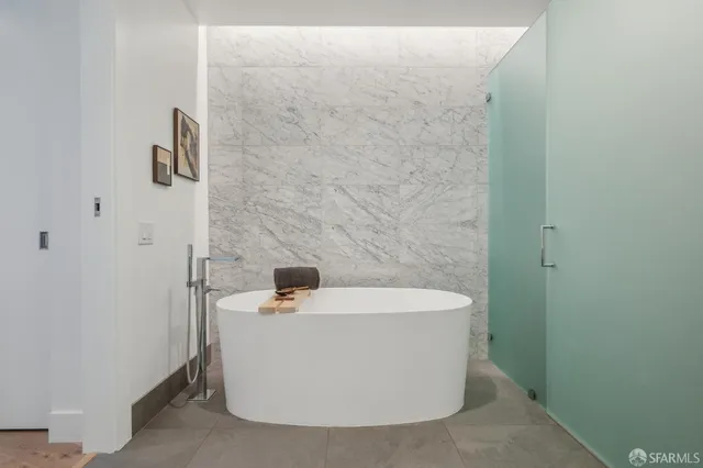 a white bath tub sitting in a bathroom