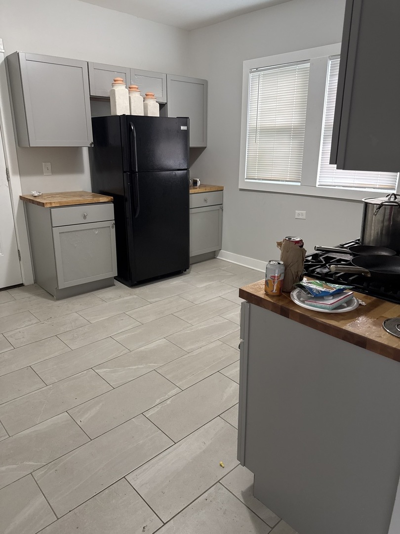 310 West 105th Street Chicago, IL 60628 - Photo 11 of 22 a kitchen with stainless steel appliances a refrigerator and a stove top oven