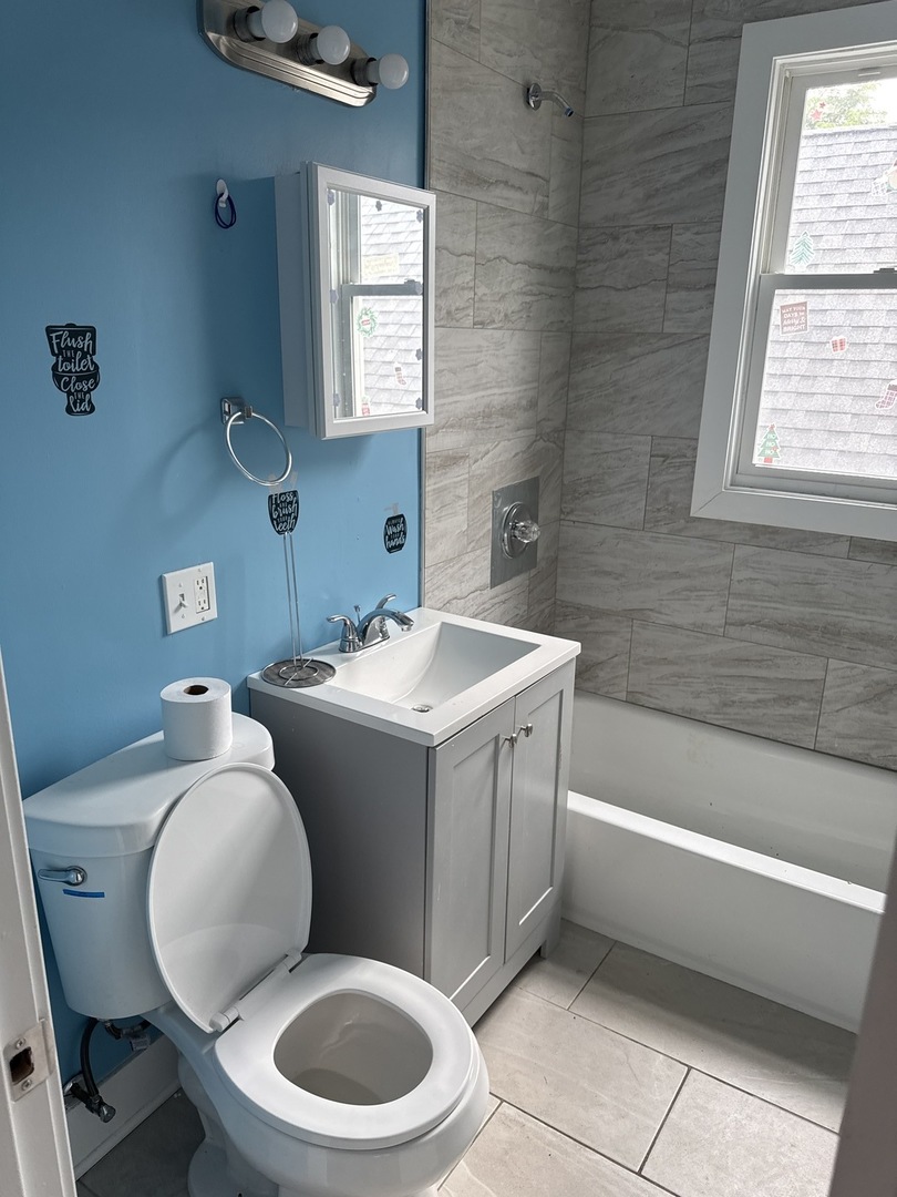 310 West 105th Street Chicago, IL 60628 - Photo 18 of 22 a bathroom with a toilet a sink and bathtub
