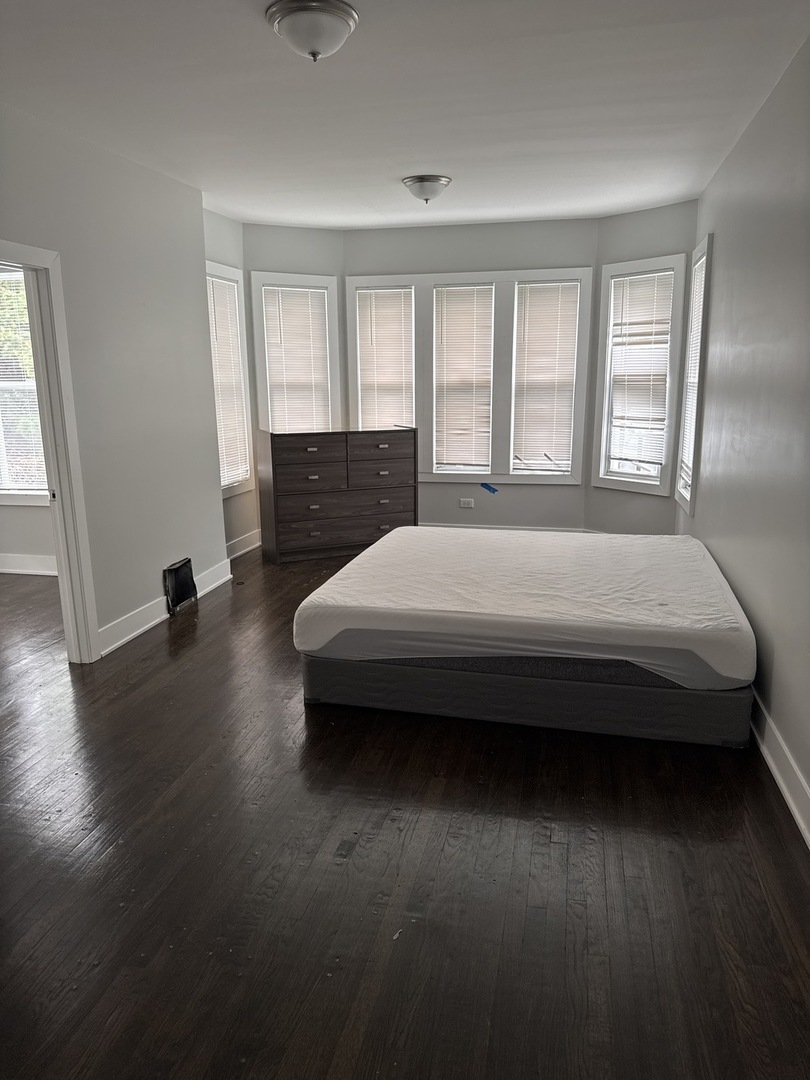 310 West 105th Street Chicago, IL 60628 - Photo 4 of 22 a bedroom with a bed and wooden floor