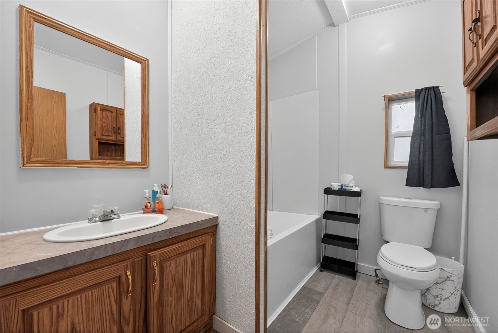 19941 Rhododendron Drive East Bonney Lake, WA 98391 - Photo 13 of 16 a bathroom with a toilet a sink and mirror