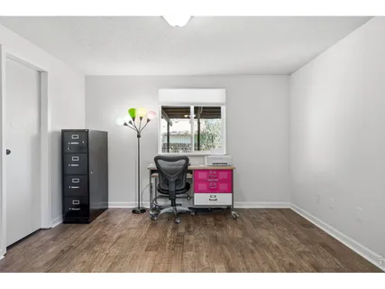 a bedroom with a bed a table and chair