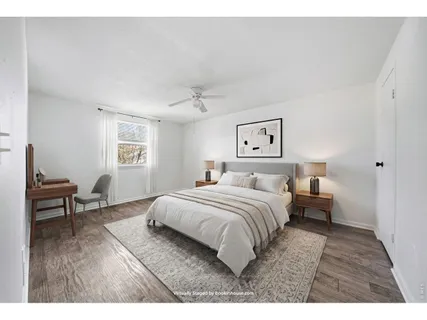 a bedroom with a bed and a workspace