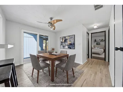 a large kitchen with cabinets wooden floor and stainless steel appliances