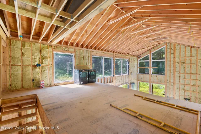 a bedroom with a bed and a mirror