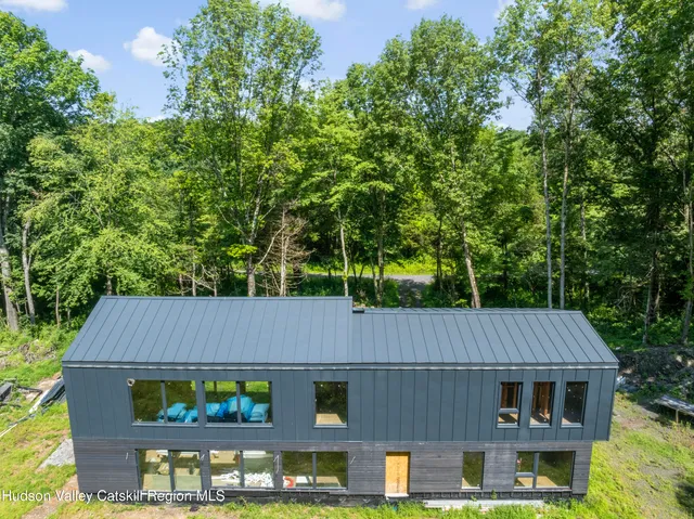 a swimming pool with large glass windows and painted walls