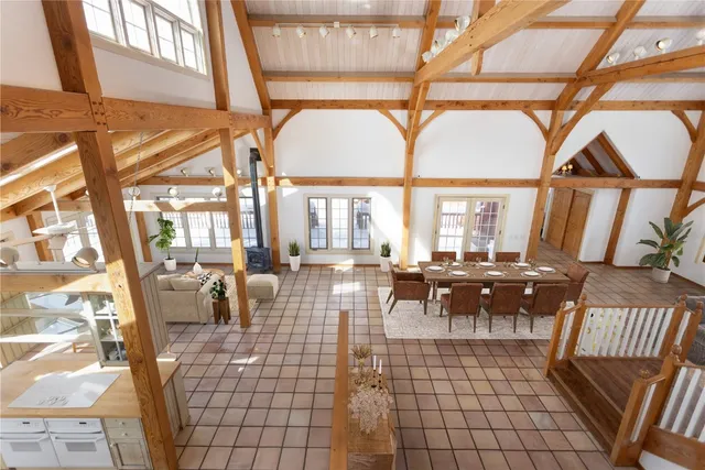 a living room with couches and a dining table with chairs