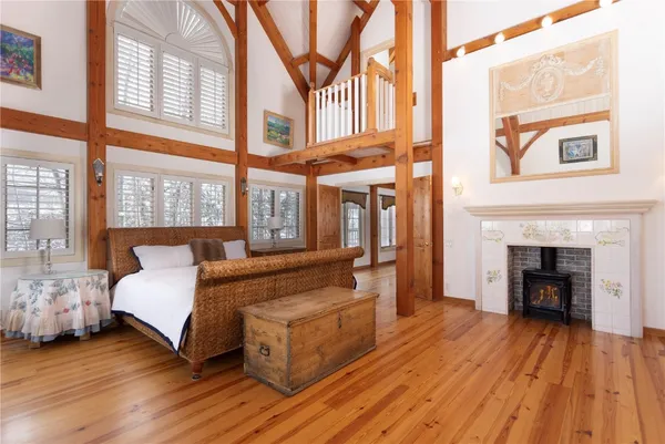 a spacious bedroom with a bed and a fireplace