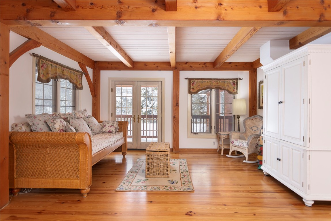 300 Gold Hill Road Breckenridge, CO 80424 - Photo 26 of 50 a living room with furniture large windows wooden floor and a table