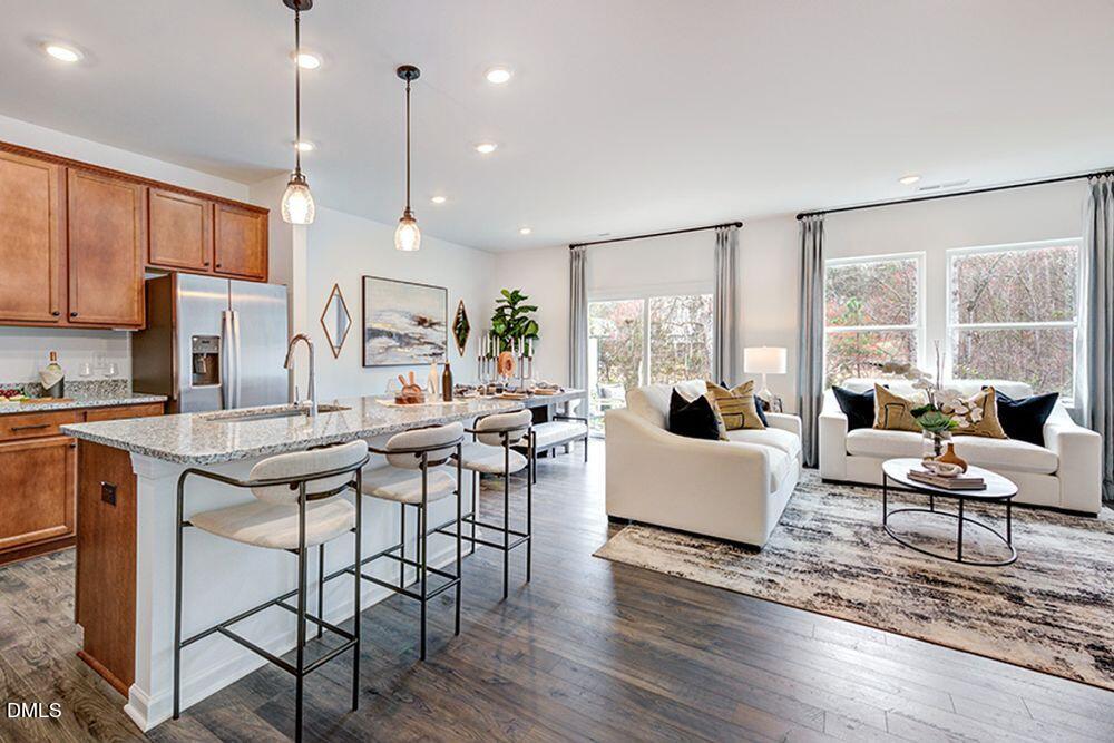 228 Hank Way Angier, NC 27501 - Photo 9 of 43 a living room with furniture wooden floor and a large window