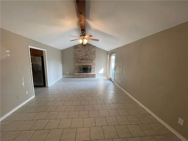 a view of an empty room with a fireplace