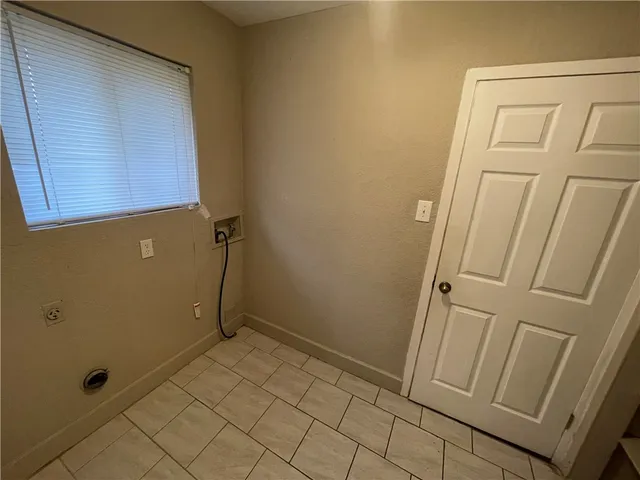 en empty room with windows and fan