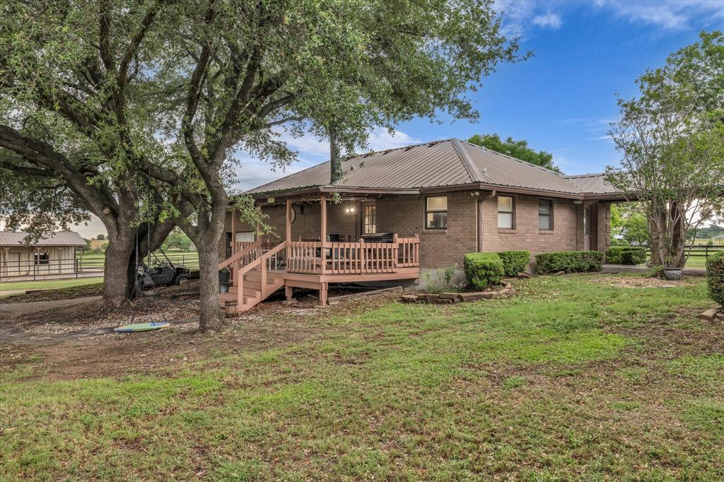 15796 Chapel Road Lorena, TX 76655 - Photo 19 of 28 Rear view of house with a metal roof, a deck, and brick siding