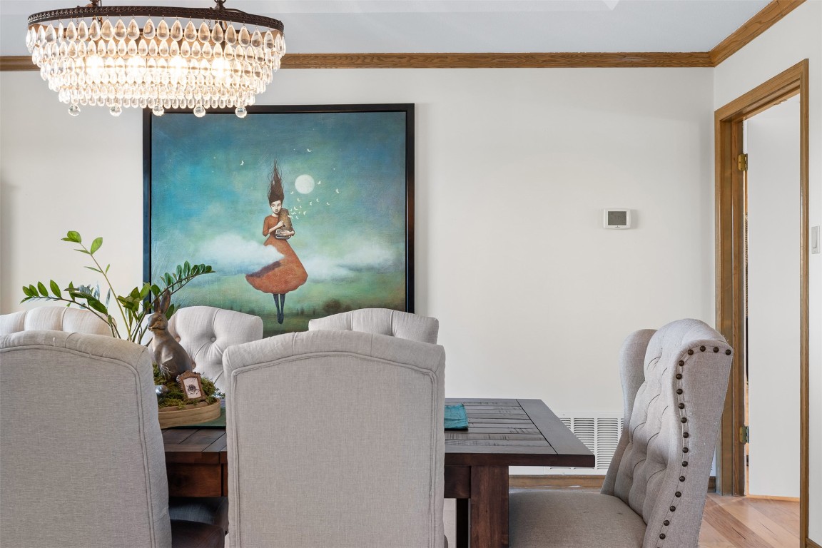 197 Live Oak Cemetery Road Killeen, TX 76542 - Photo 17 of 36 Dining room featuring crown molding, wood finished floors, a desk, and a chandelier