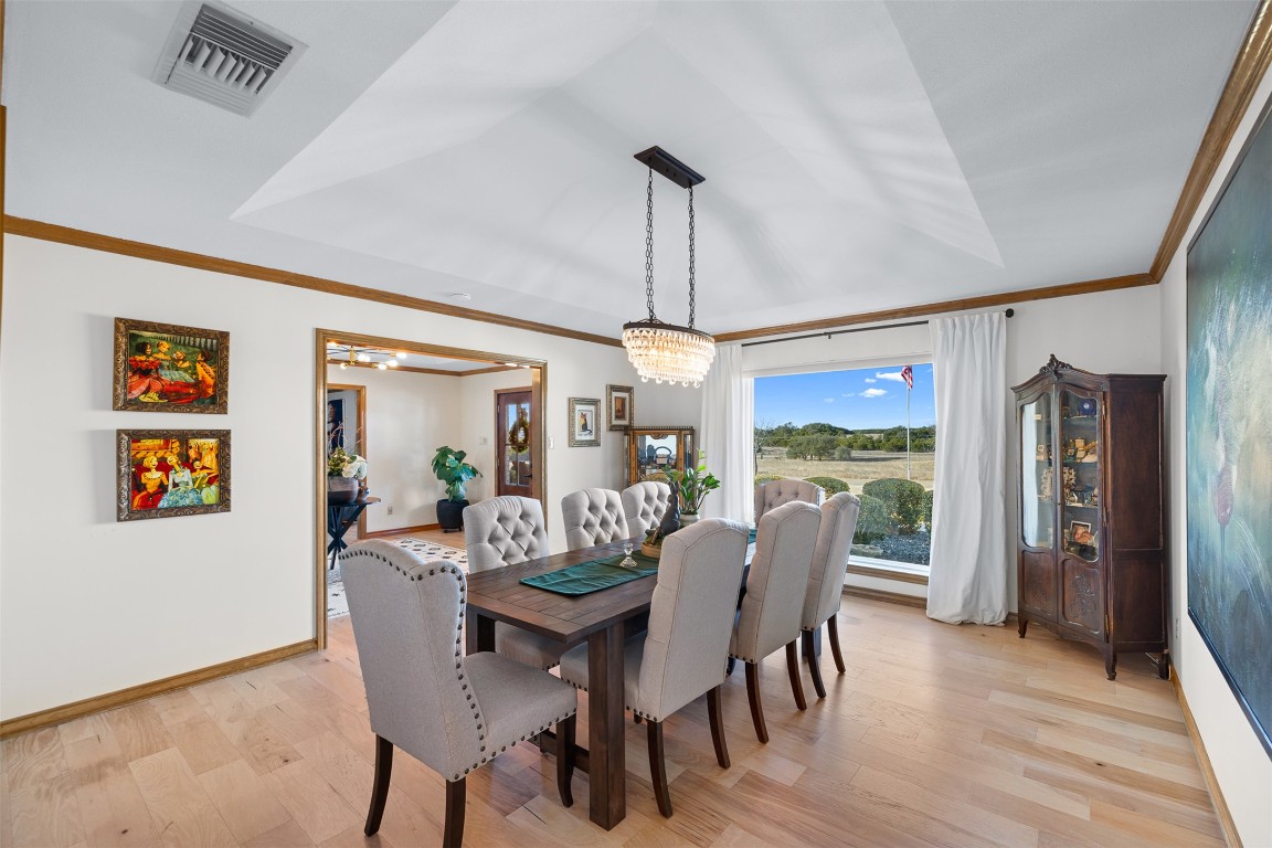 197 Live Oak Cemetery Road Killeen, TX 76542 - Photo 18 of 36 a dining room with furniture a chandelier and wooden floor