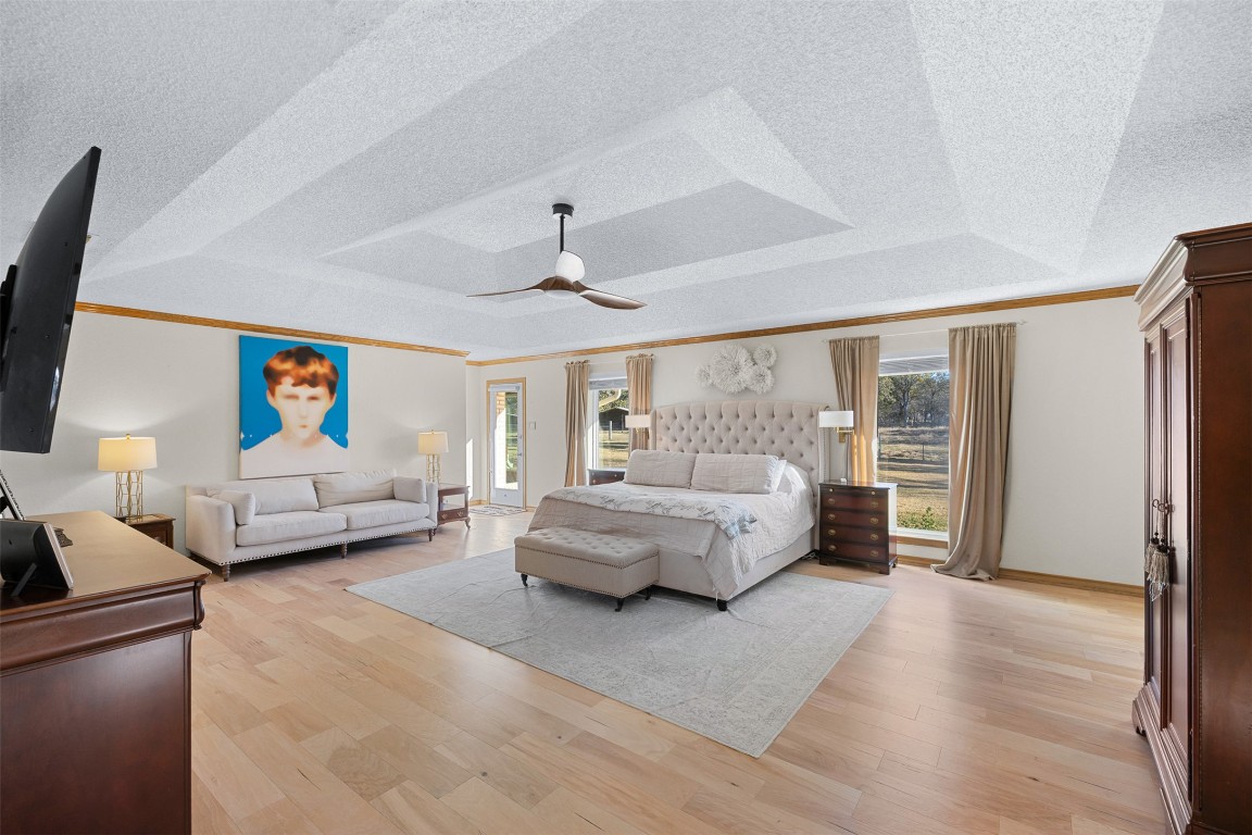 197 Live Oak Cemetery Road Killeen, TX 76542 - Photo 27 of 36 Bedroom with a textured ceiling, crown molding, multiple windows, light wood-style floors, and a ceiling fan