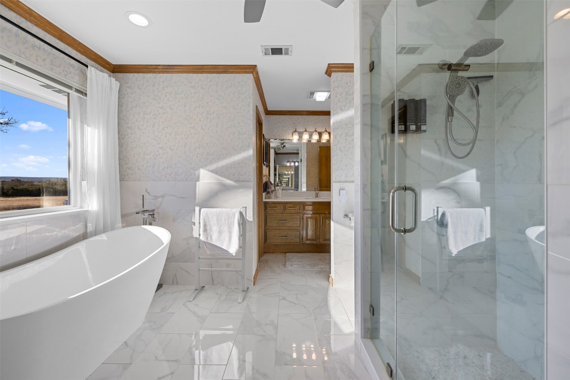 197 Live Oak Cemetery Road Killeen, TX 76542 - Photo 28 of 36 Full bathroom with crown molding, a freestanding bath, vanity, wallpapered walls, and a marble finish shower