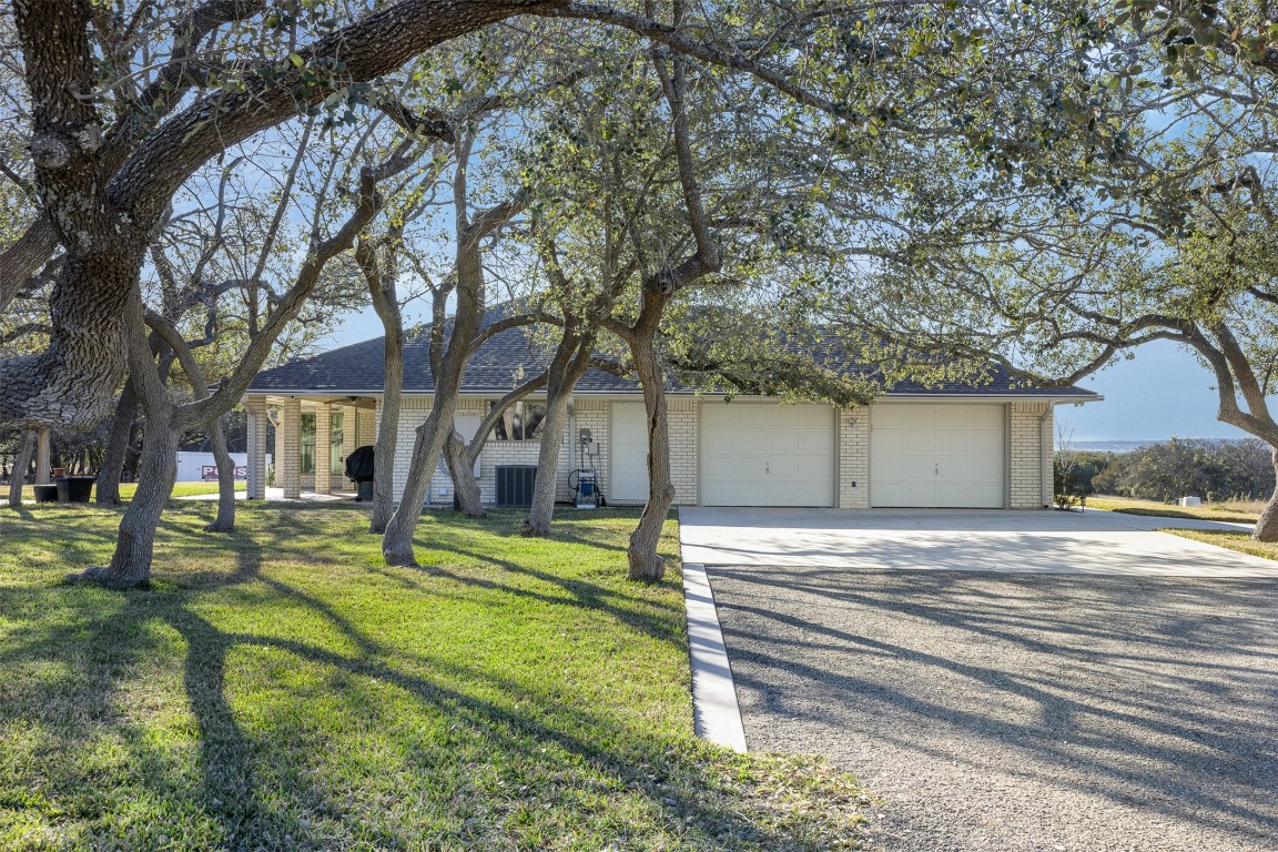 197 Live Oak Cemetery Road Killeen, TX 76542 - Photo 6 of 36 a front view of a house with a garden and trees