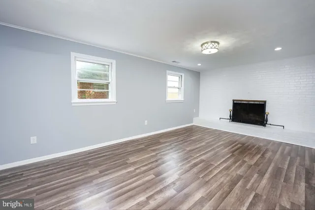 a view of a livingroom with wooden floor and a window
