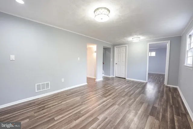 a view of an empty room and wooden floor