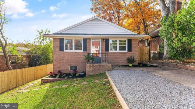 a front view of a house with a yard and seating space