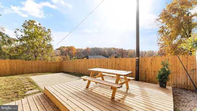 a balcony with wooden floor and lake view