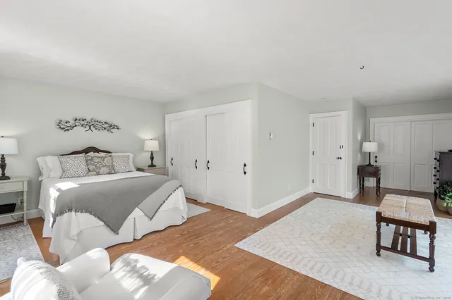 a bedroom with a bed and a table in it