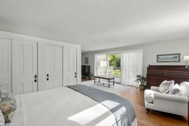 a spacious bedroom with a bed a couch and a couch