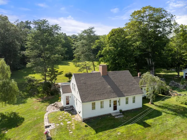 an aerial view of residential houses with yard